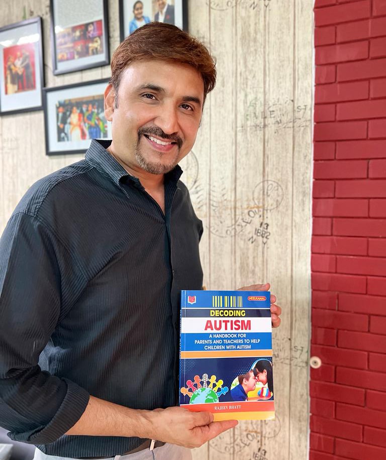 Rajeev Bhatt with Decoding Autism book